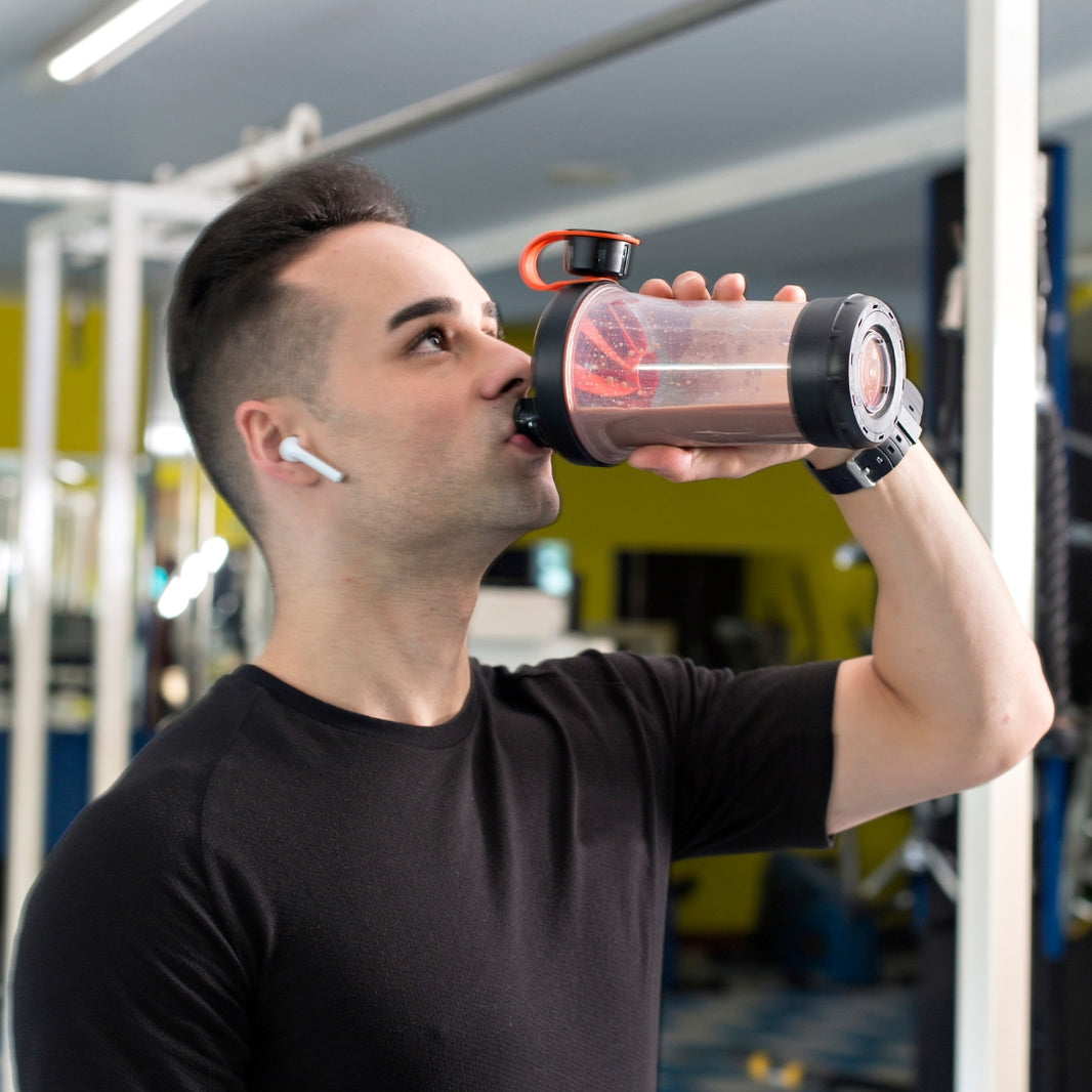 Muscular man drinking a nutritious protein shake after intense workout.